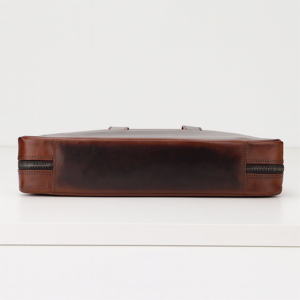 Bottom view of classic brown leather men’s briefcase with zippers
