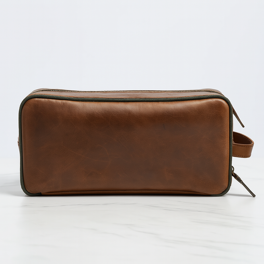 Front view of brown leather travel toiletry bag with green trim