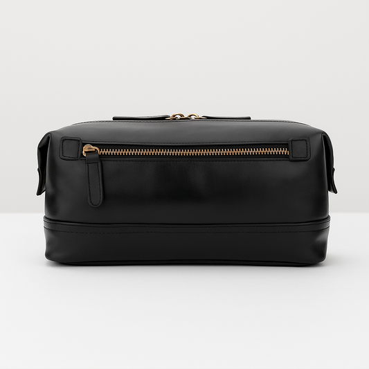 Sleek black leather dopp kit with gold zipper front view.