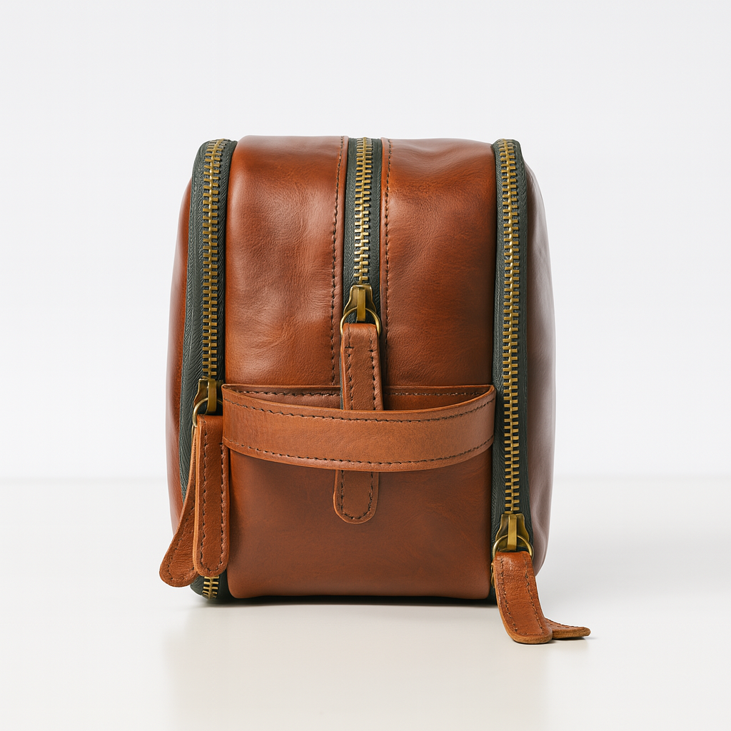 Side profile of brown leather dopp kit with dual zippers and handle.