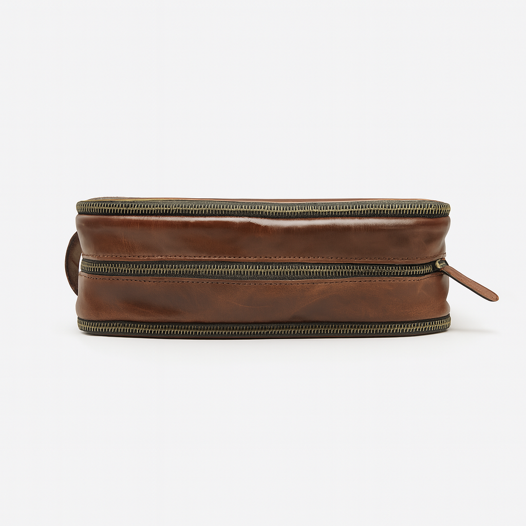 Top view of brown leather dopp kit with dual brass zippers