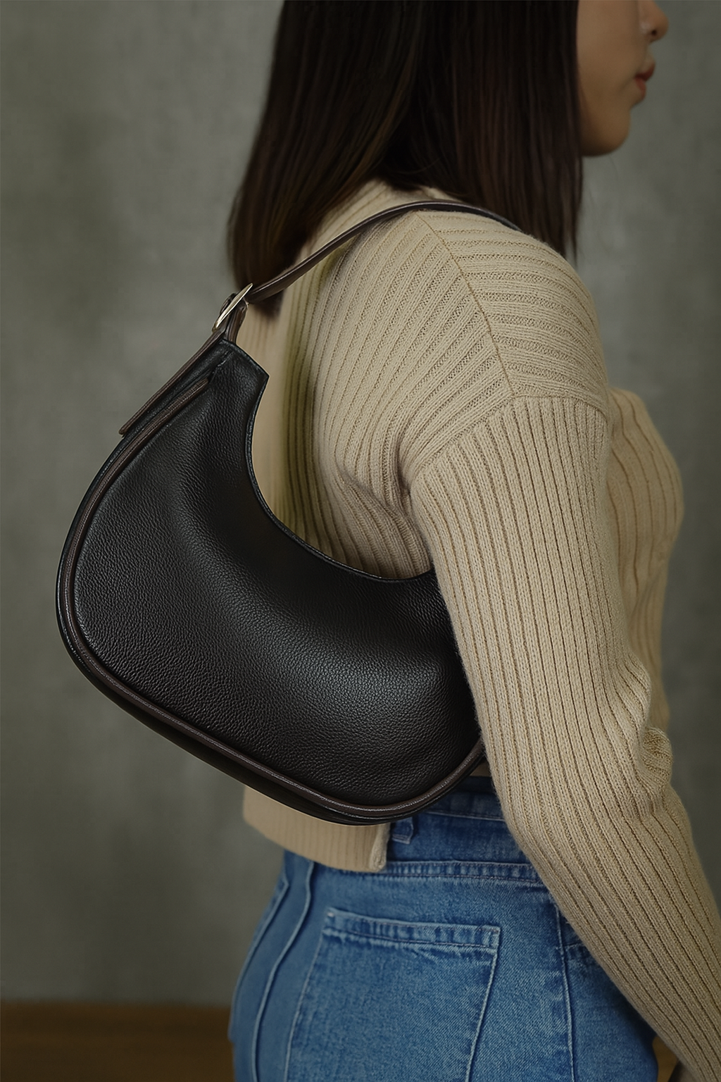 MoonLuxe Crescent Shoulder Bag in black, worn on shoulder.